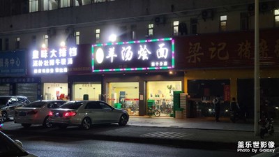 招牌子模糊不清，那么大光暈。這相機(jī)怎對(duì)得起八千元的價(jià)格。
